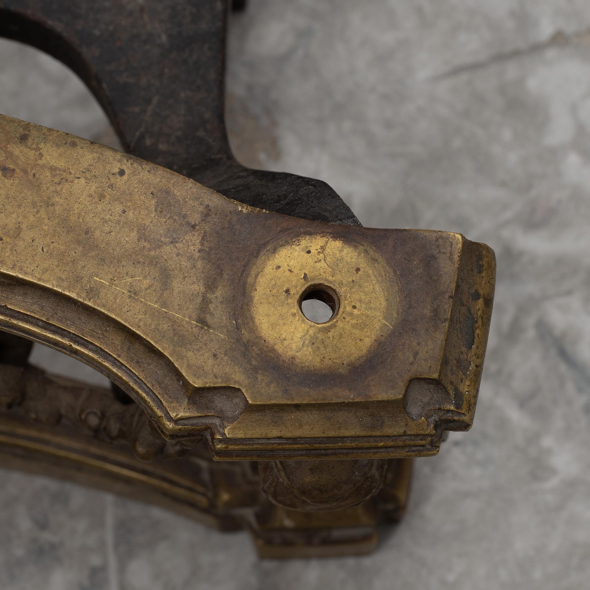 A pair of brass and forged iron andirons, late 19th century.
