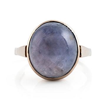 An 18K white gold ring set with a star sapphire.