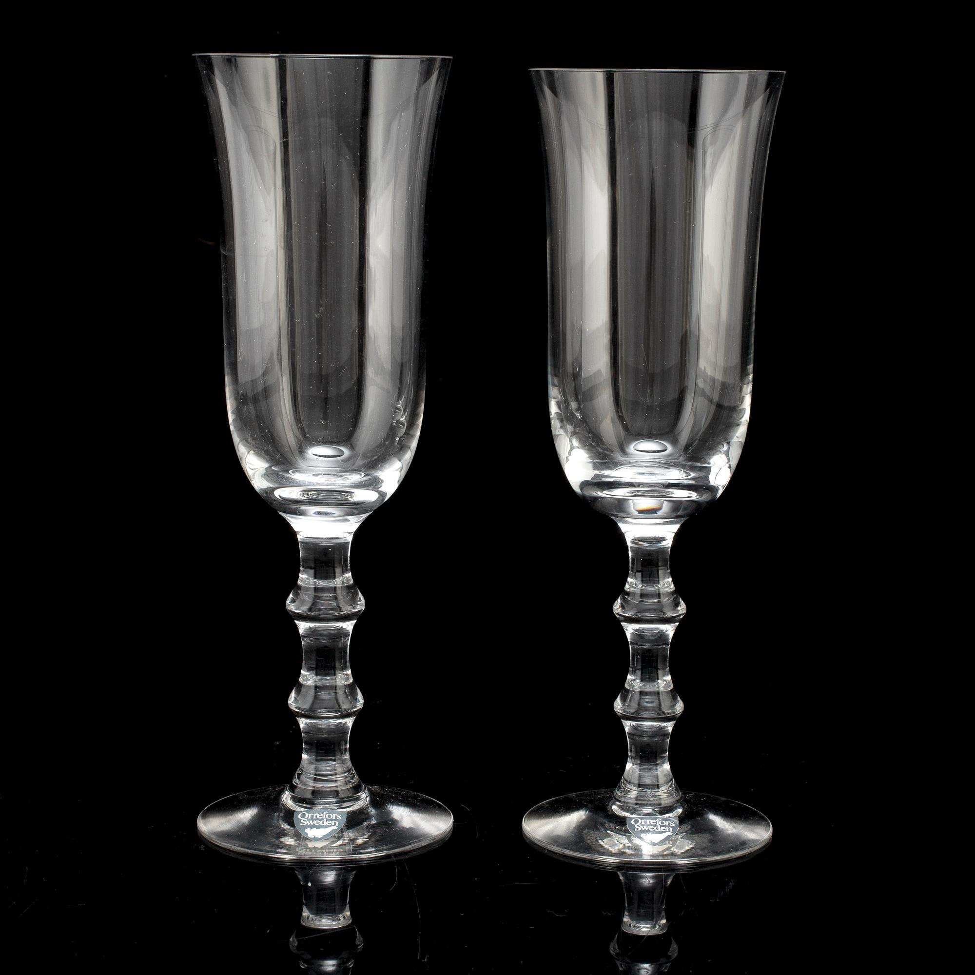 A set of twelve champagne glasses by Simon Gate.