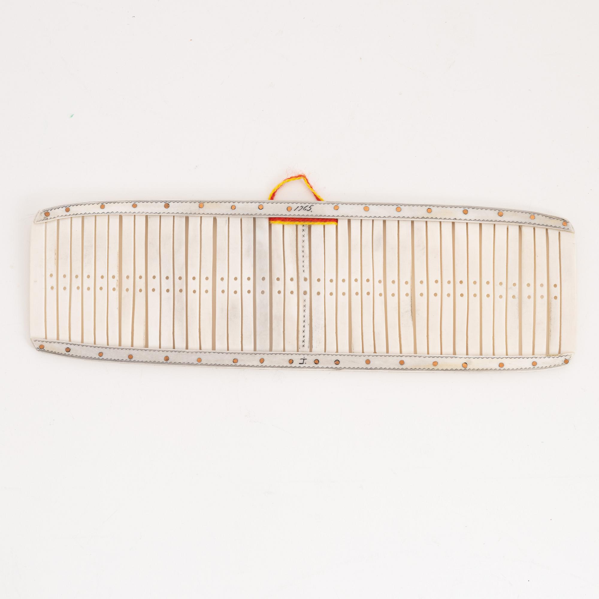 A reindeer weaving device by Johan Tuuri, signed and dated 1965.