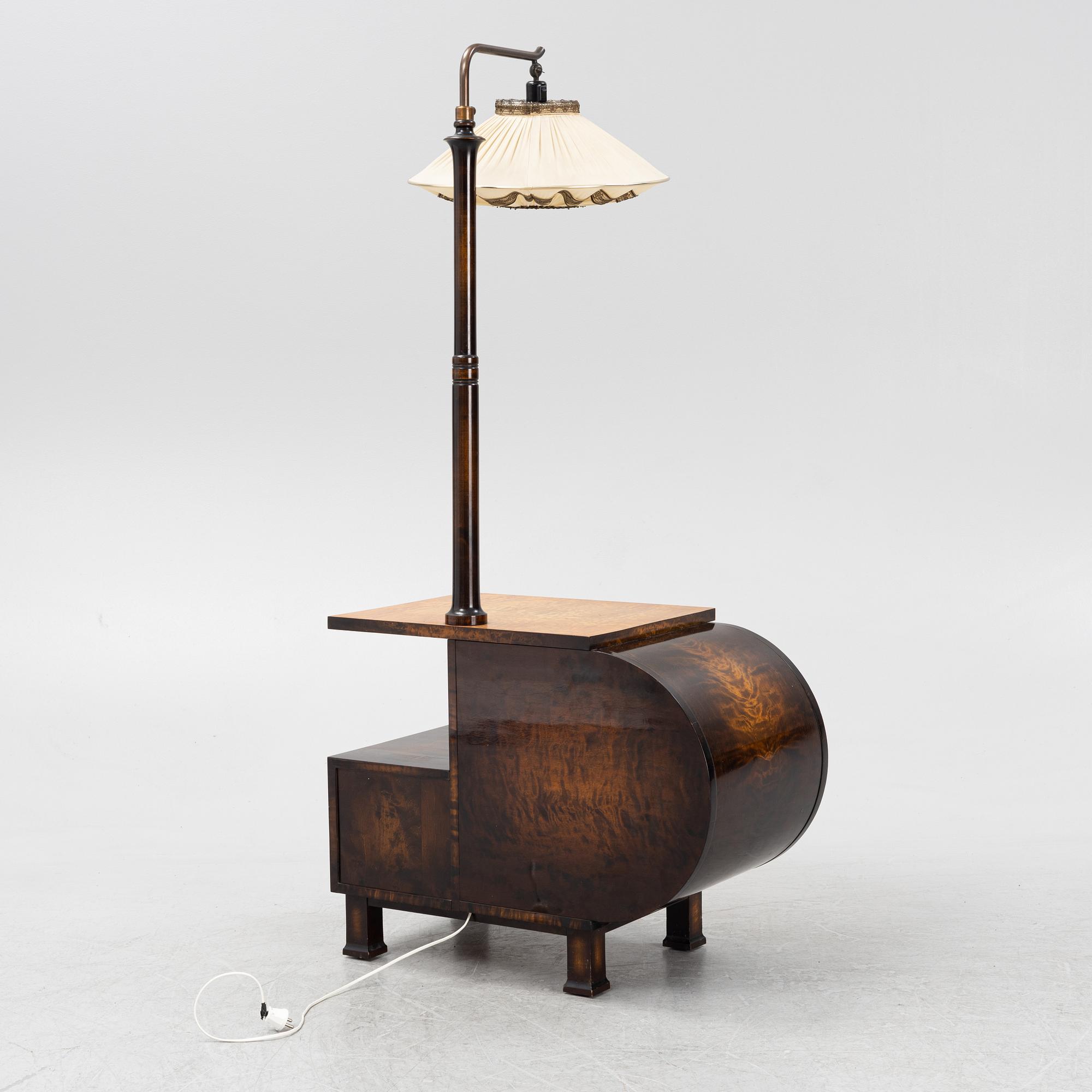 A 1930s sidetable with a lamp.