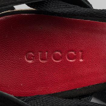 A pair of Gucci wedge shoes size 36.