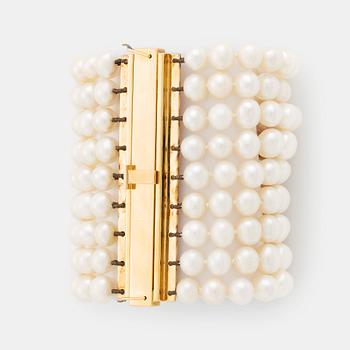 A nine strand cultured fresh water pearl bracelet with  clasp in 18K gold.