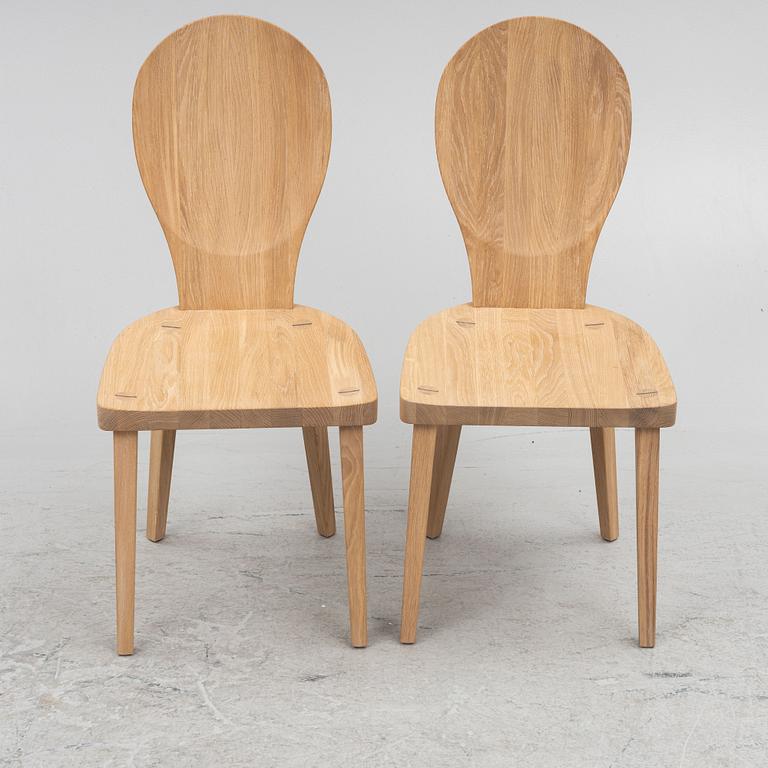 Carl Malmsten, a pair of "Skedblad" chairs, Tre Sekel, Sweden, 21st century.