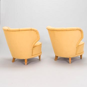 A pair of mid-20th century armchairs.