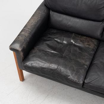 A leather and teak sofa, 1960-70s.