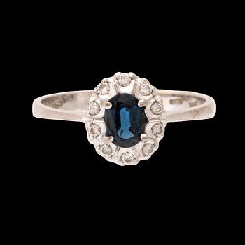 An 18K white gold carmosé ring set with an oval faceted sapphire and round brilliant-cut diamonds, Alessandria Italy.