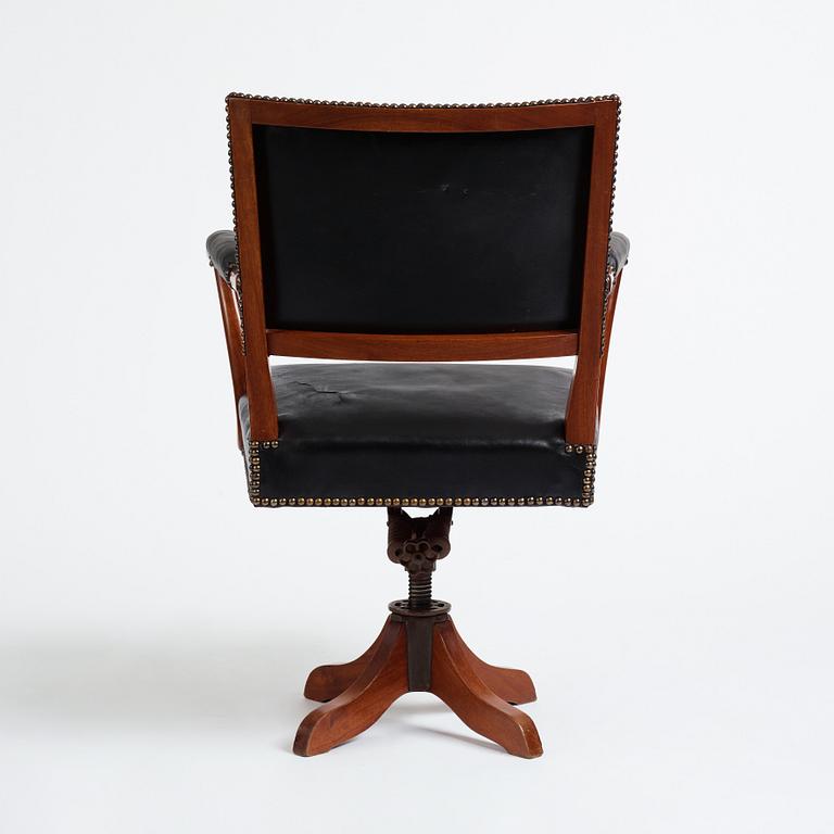 Josef Frank, a mahogany and black leather swivel chair, modified version of model 695, Svenskt Tenn, ca 1956-1957.