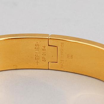 HERMÈS, a 'Clic H' bangle.