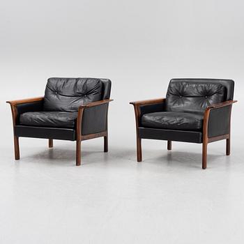 A pair of leather and rosewood easy chairs,  Bröderna Andersson, Ekenässjön, Sweden 1960s.