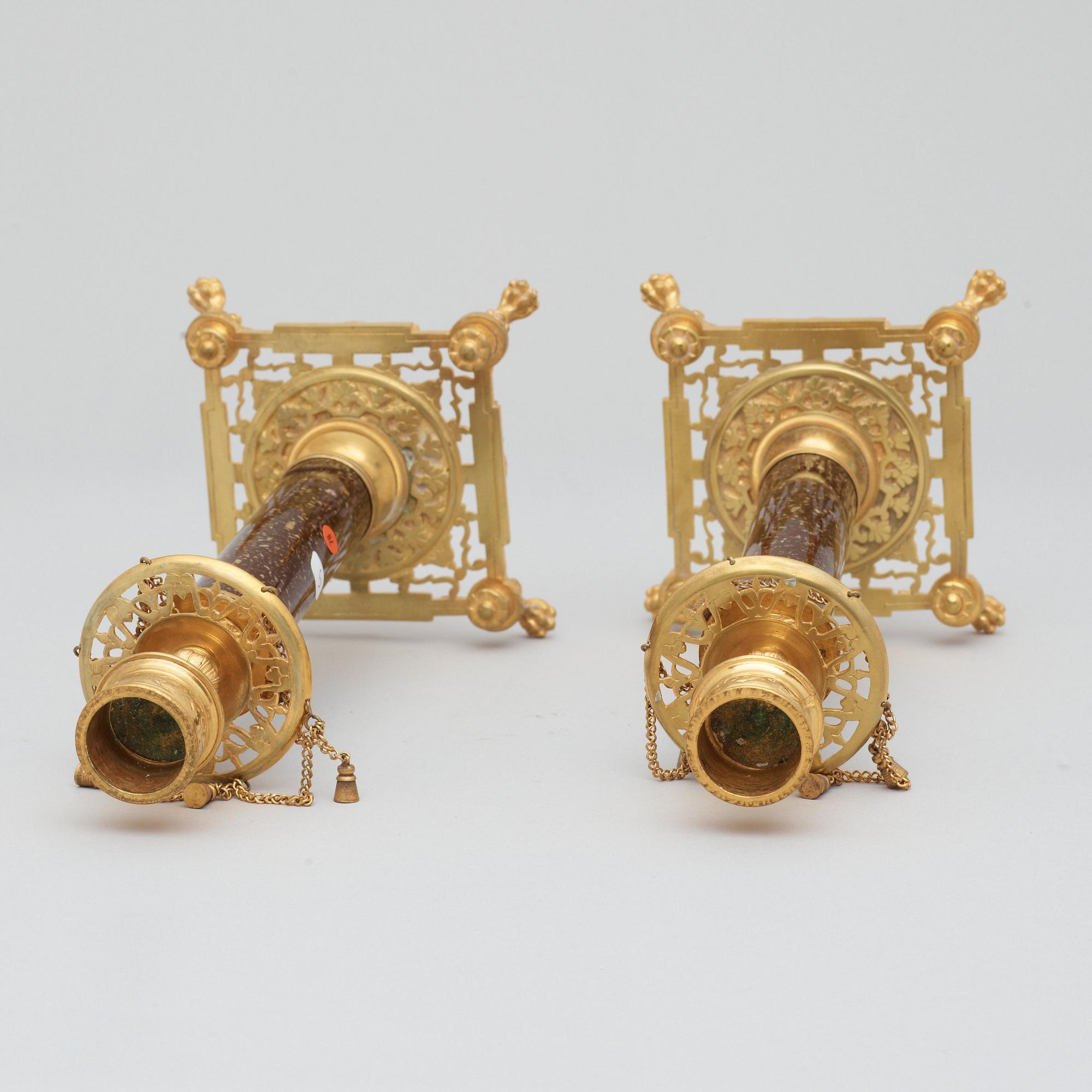 A pair of Swedish late 19th century brass and porphyry-imitation glass candlesticks.