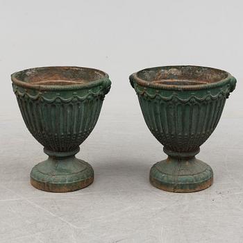 A pair of early 20th century iron garden urns.