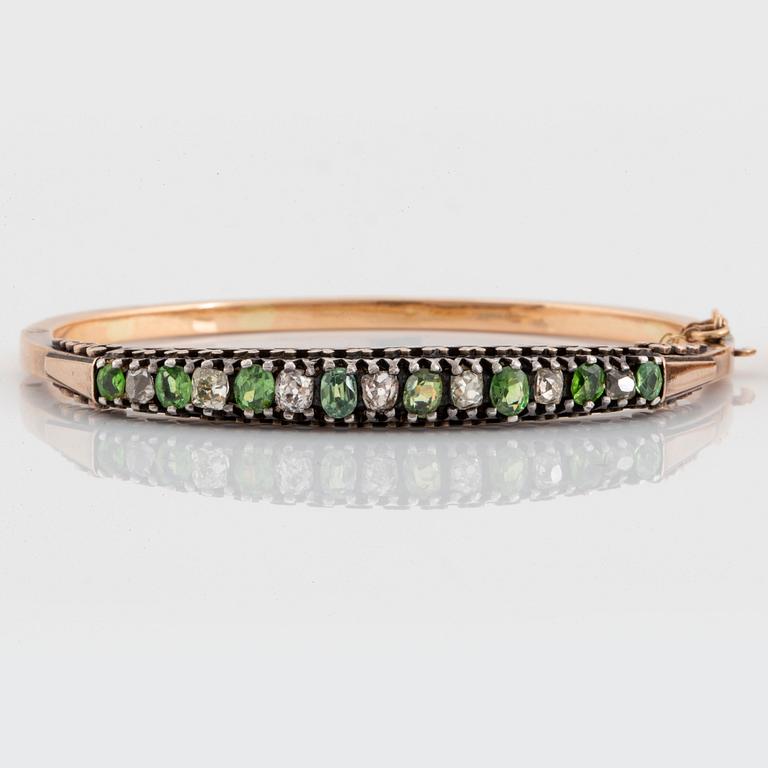 A pair of 14K gold and silver bangles set with demantoid garnets and old-cut diamonds.