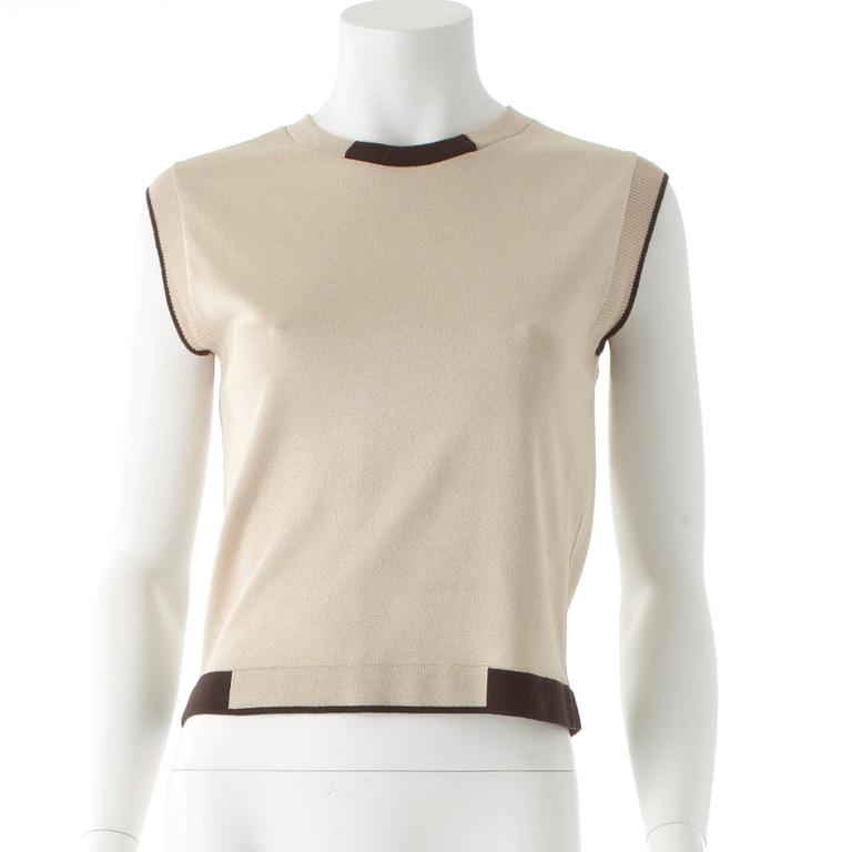 CHANEL, a gold colored and brown sweater set consisting of a sleevles top and cardigan.