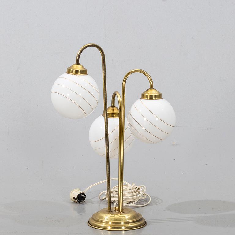 A brass and metall table lamp from the second half of the 20th century.