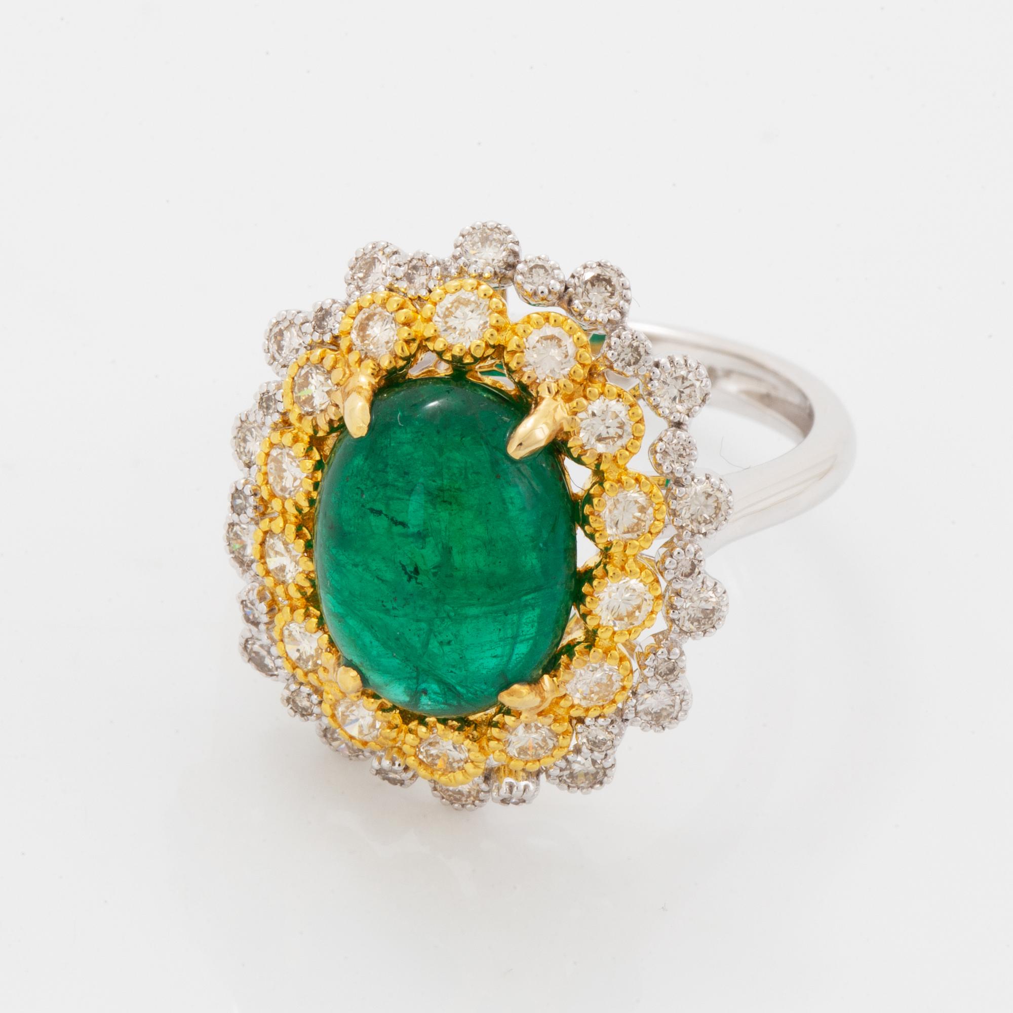 Cabochon-cut emerald and brilliant-cut diamond ring.