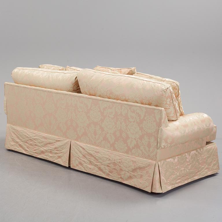 A sofa upholstered with silk damask.