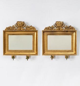 A pair of Empire giltwood two-branch girandole mirrors, Sweden, first part 19th century.