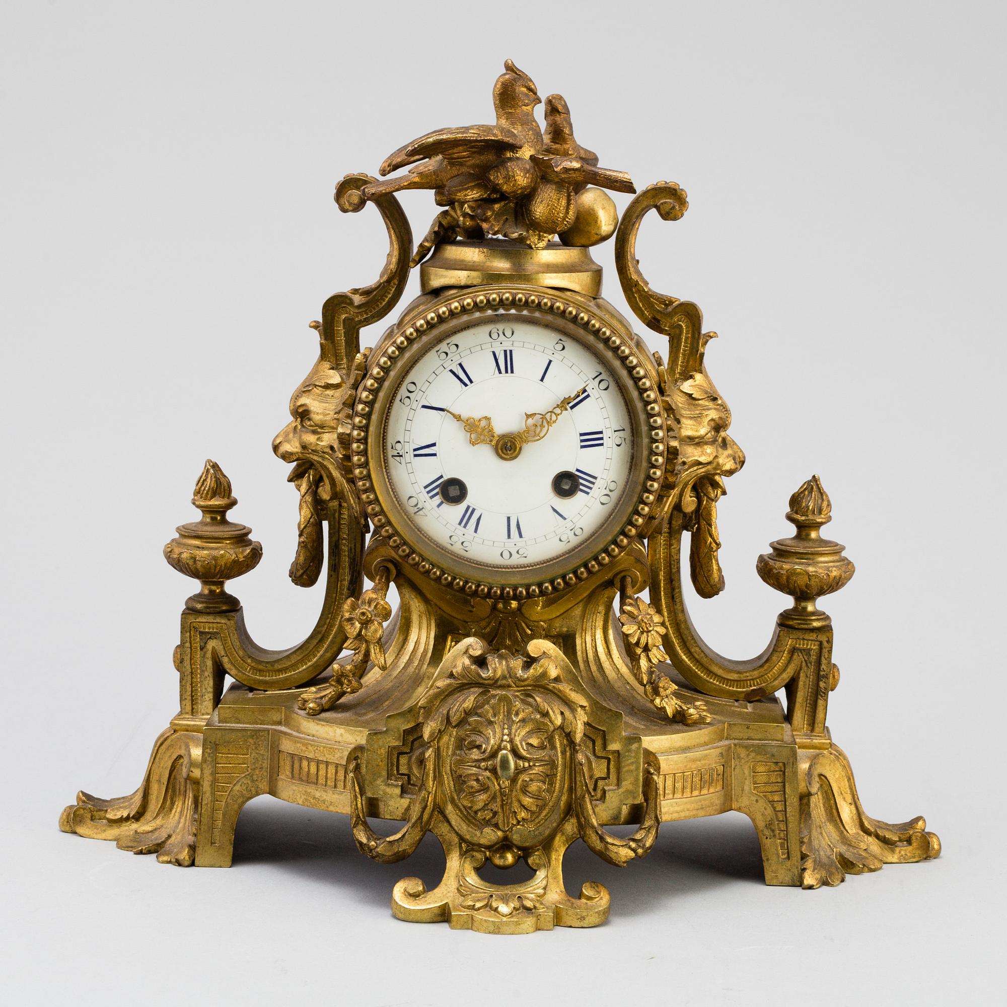 A table CLOCK and a pair of candelabra, second part of 19th century.