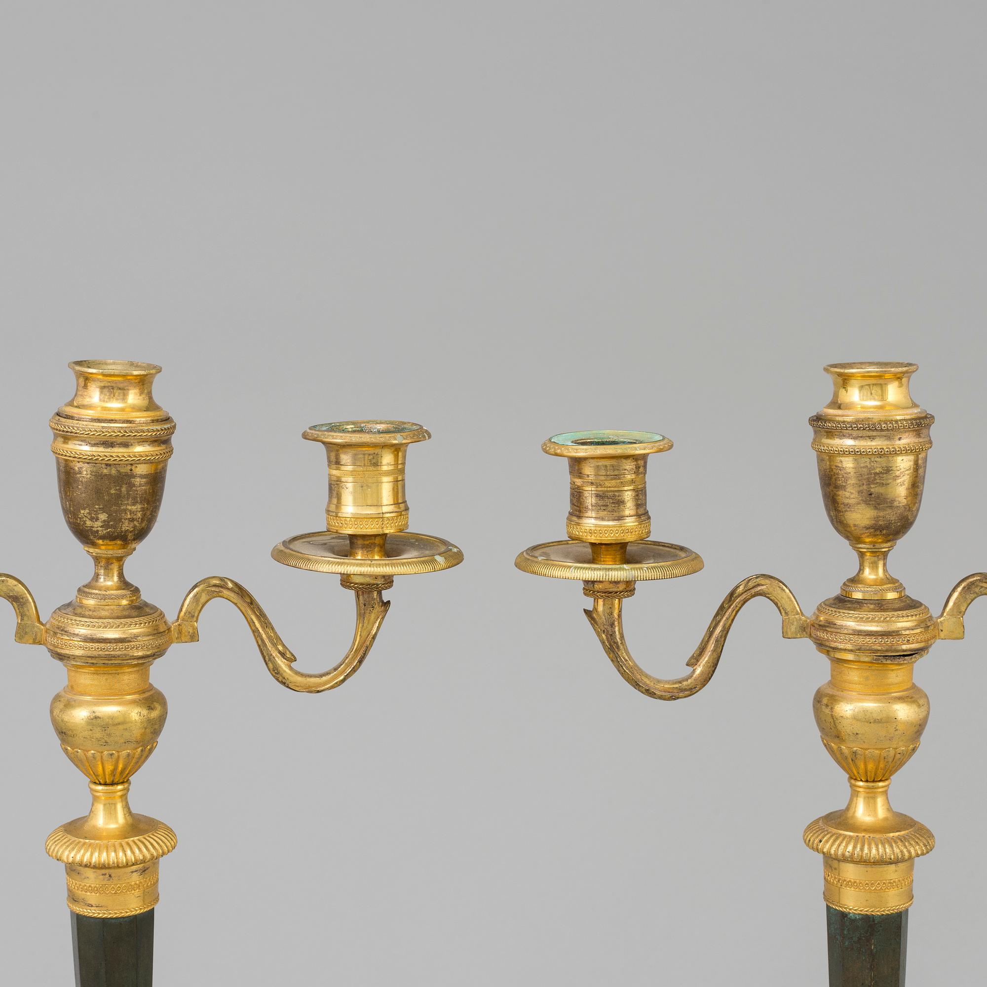A pair of French Directoire late 18th century ormolu candelabra for three candles.