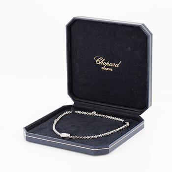 An 18K white gold Chopard "Happy Diamonds" necklace set with round brilliant-cut diamonds.