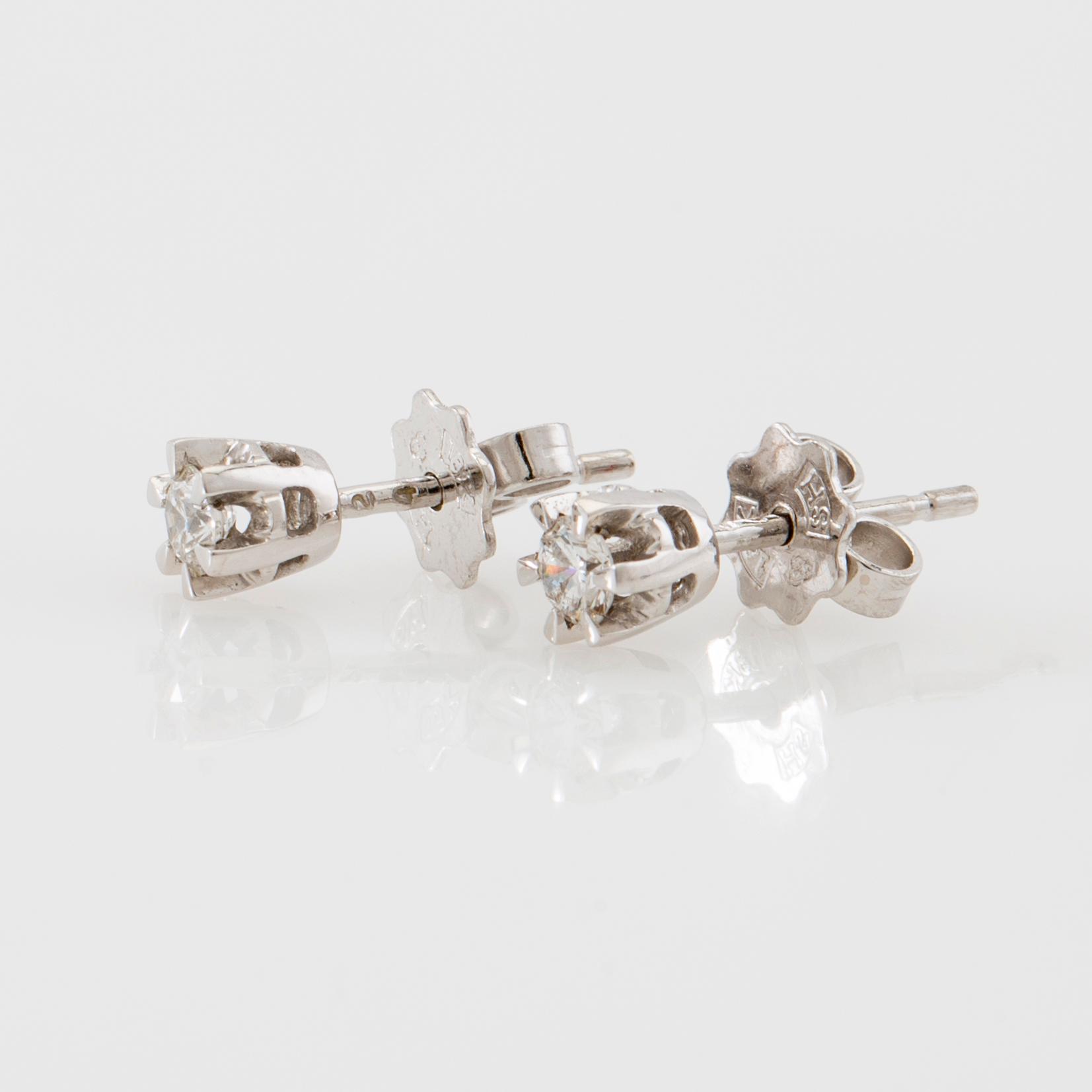 Earrings, a pair of 18K white gold set with round brilliant-cut diamonds.