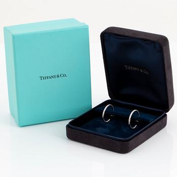 A pair of Tiffany "Metro" 18K white gold hoops set with round brilliant-cut diamonds.
