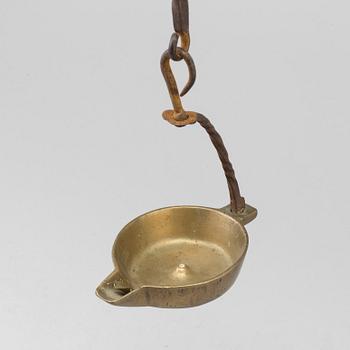 A 18th century oil lamp.