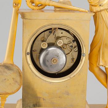An Empire table clock, dial marked "L Ravrio Bronzier à Paris Mesnil H", fist half of the 20th century.
