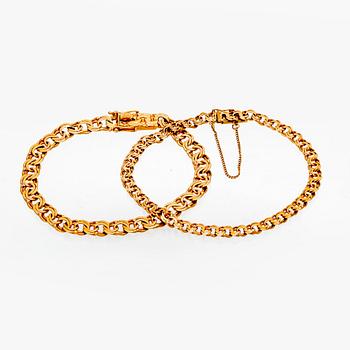 Two 18K gold bracelets.