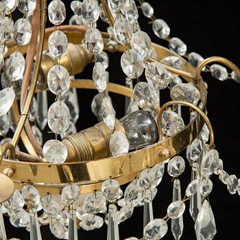 A small Swedish 20th century empire style chandelier for three candles.