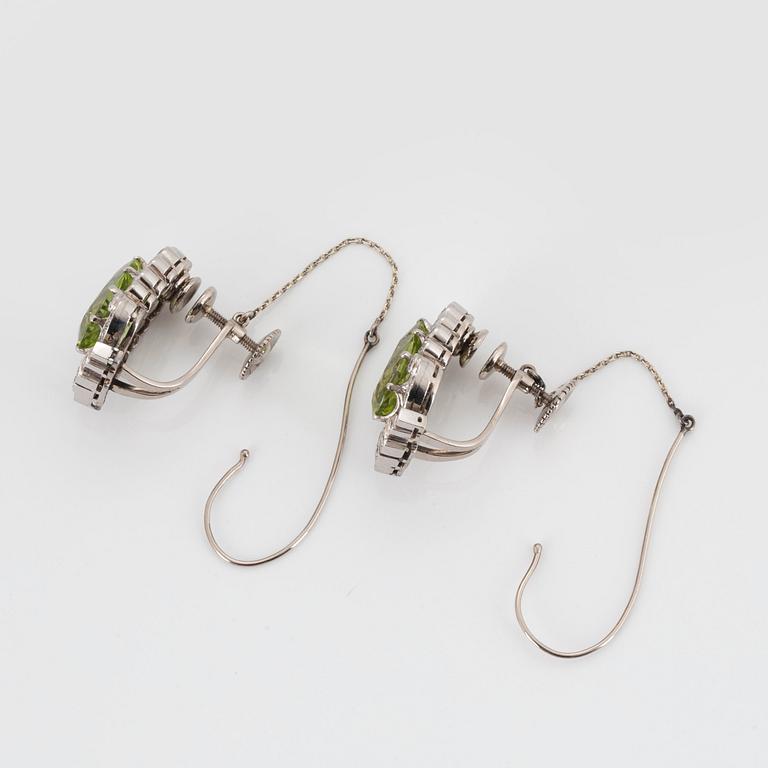 A PAIR OF EARRINGS set with peridots.