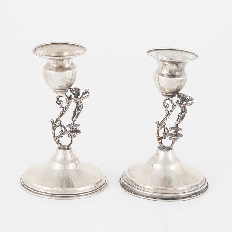 A pair of silver candle holders, marked 825.