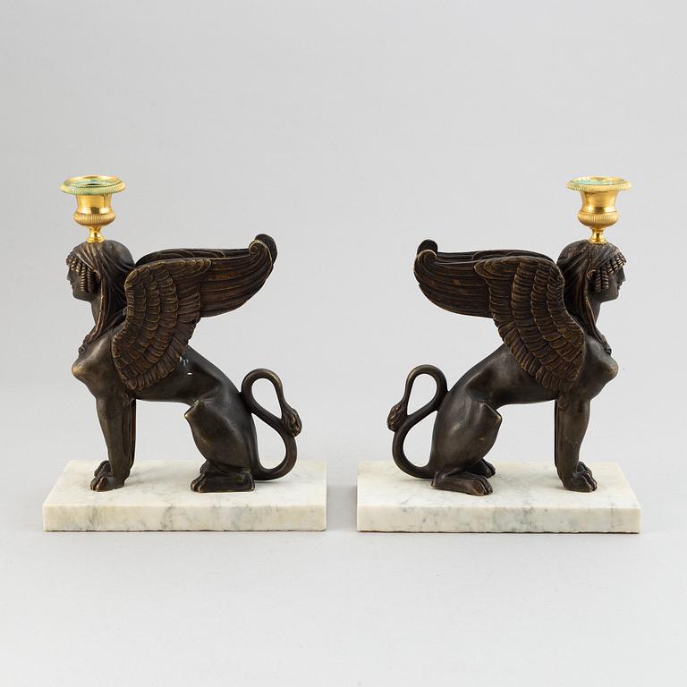 A pair of bronze and marble Empire style candlesticks, first part of the 20th Century.