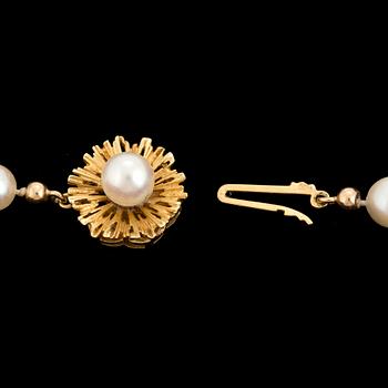 A cultured salt water pearl necklace, gold clasp.