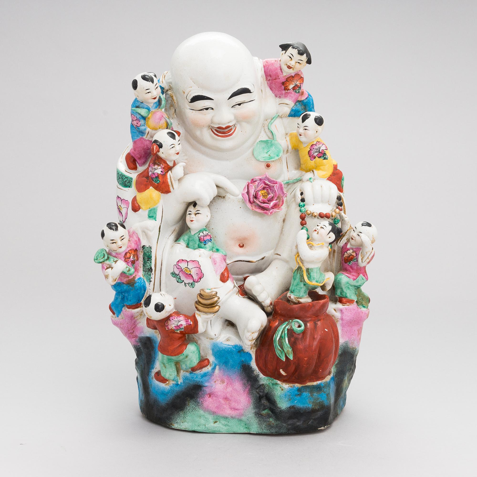 A Chinese porcelain laughing buddha with children, the 20th century.