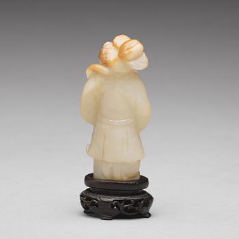 A carved nephrite figure of a boy with a lotus branch, Qing dynasty (1644-1912).