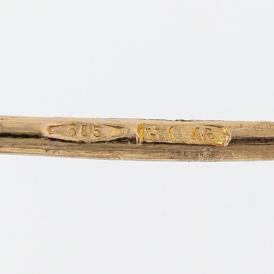 A pair of 14K gold earrings.