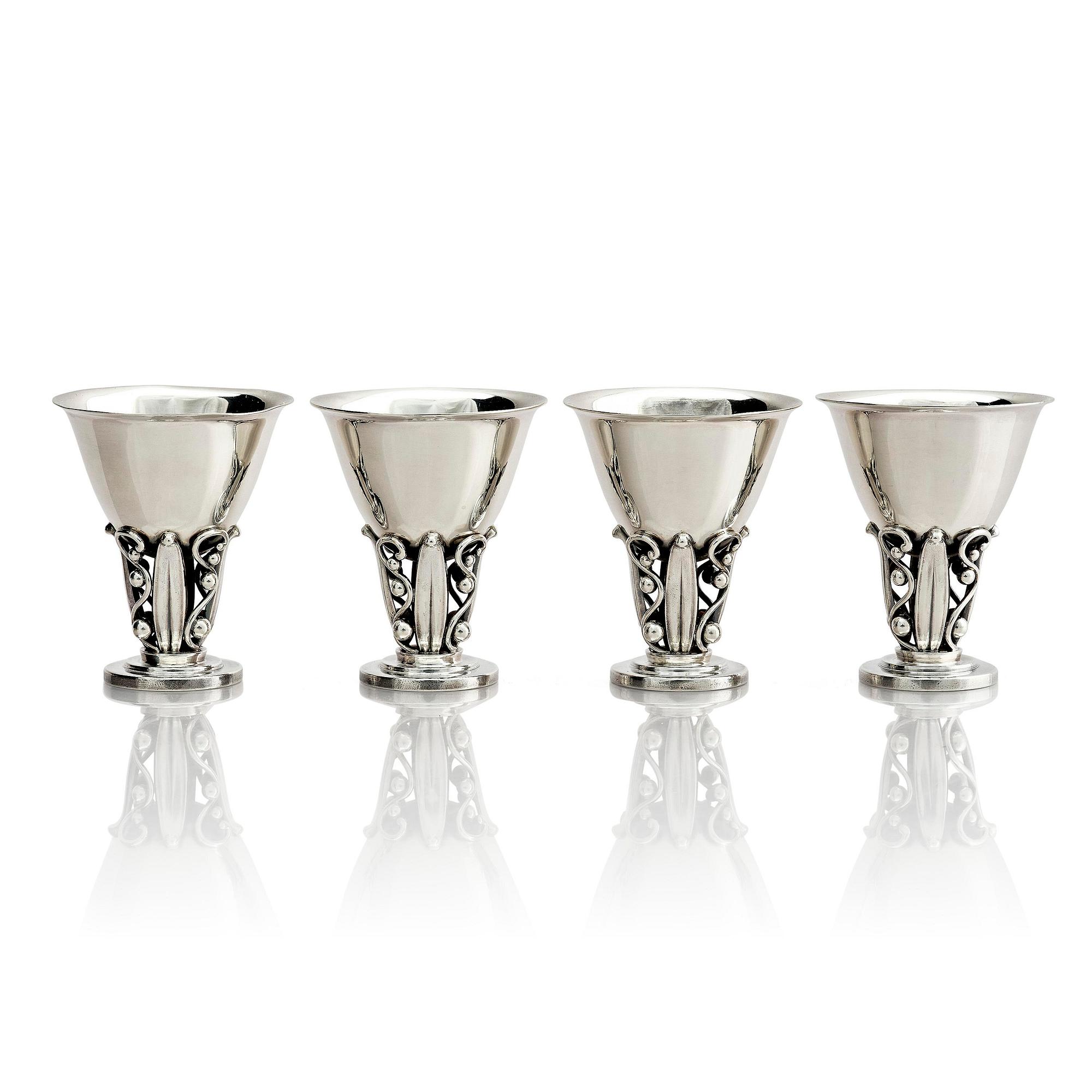 Evald Nielsen, four sterling silver beakers/cups on a foot, Denmark 20th century.
