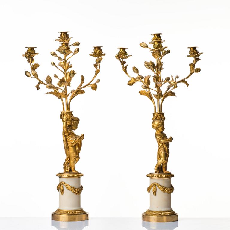 A pair of Louis XVI four light candelabra.