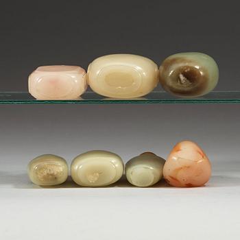 A set of 7 nephrite and stone snuff bottles with stoppers, Qing dynasty (1644-1912).