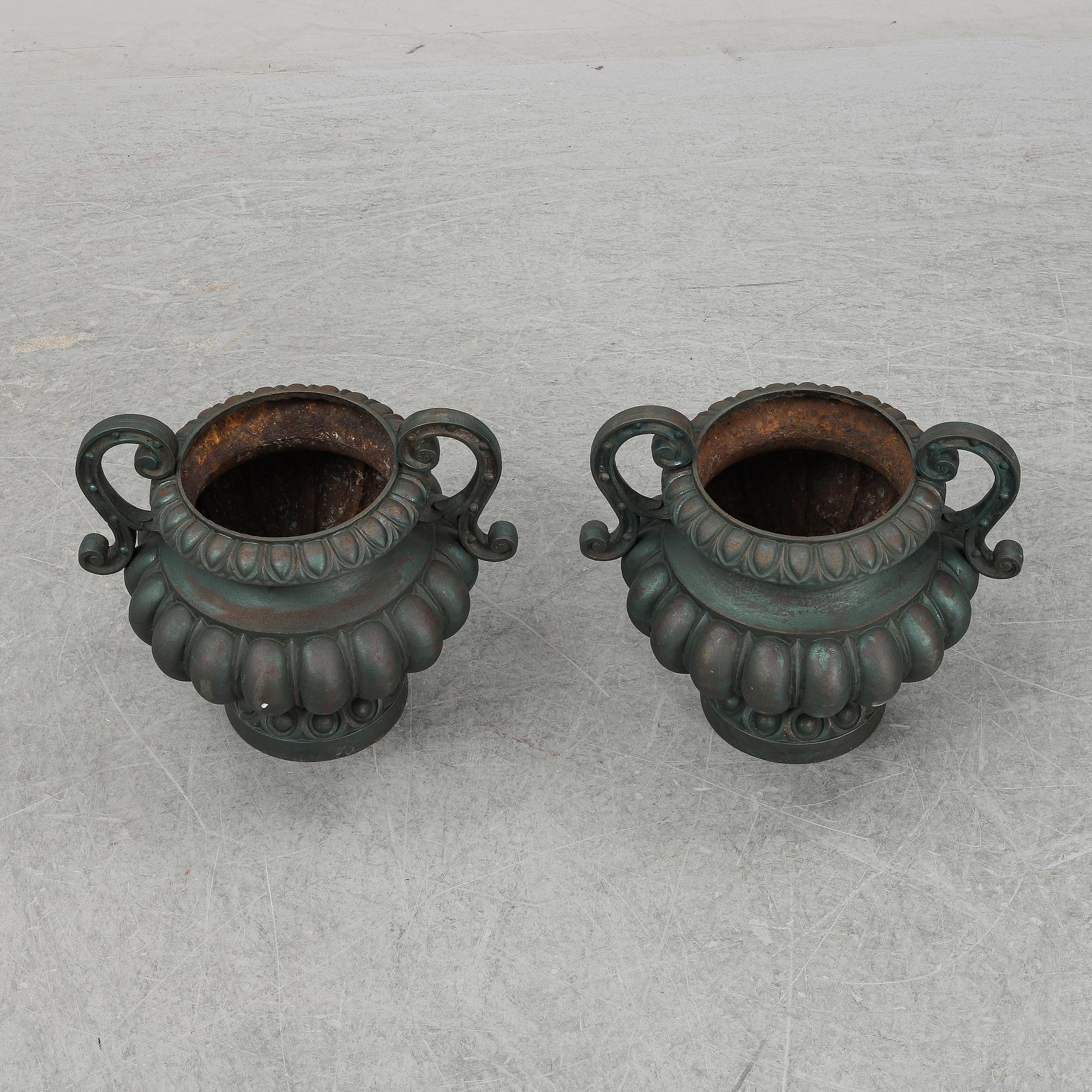A 20th Century pair of cast iron flower pots.