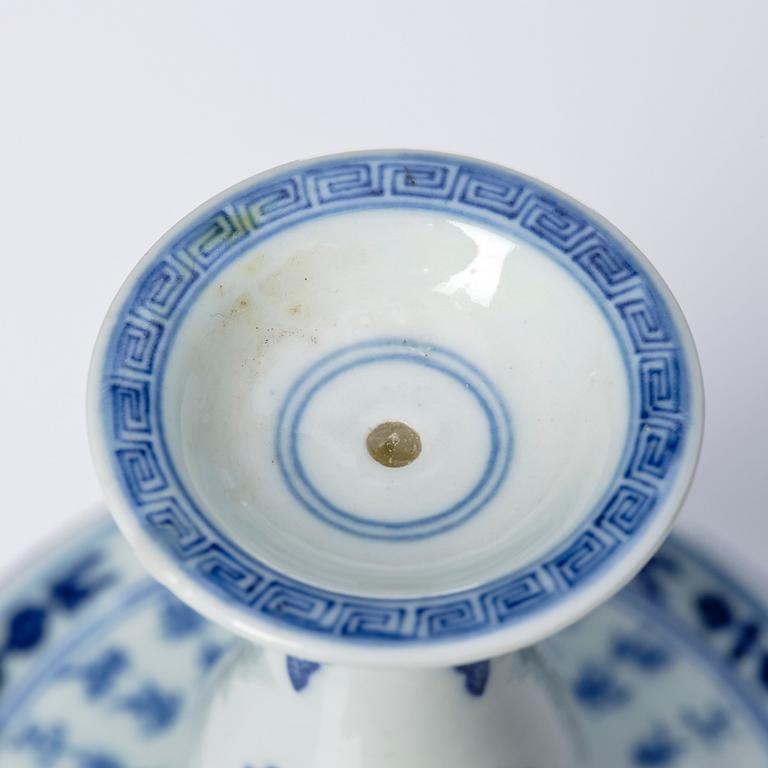 A pair of blue and white pricket candle sticks, with a poem, Qing dynasty with a Qianlong mark and of the period.