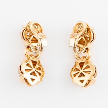 A pair of 18K gold earrings set with round brilliant-cut diamonds.