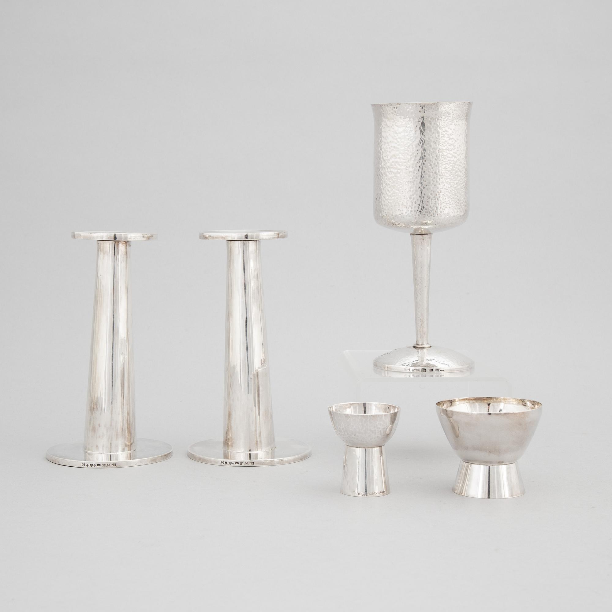 A pair of Swedish silver candlesticks and three cups, Gothenburg, 1975 - 1978.