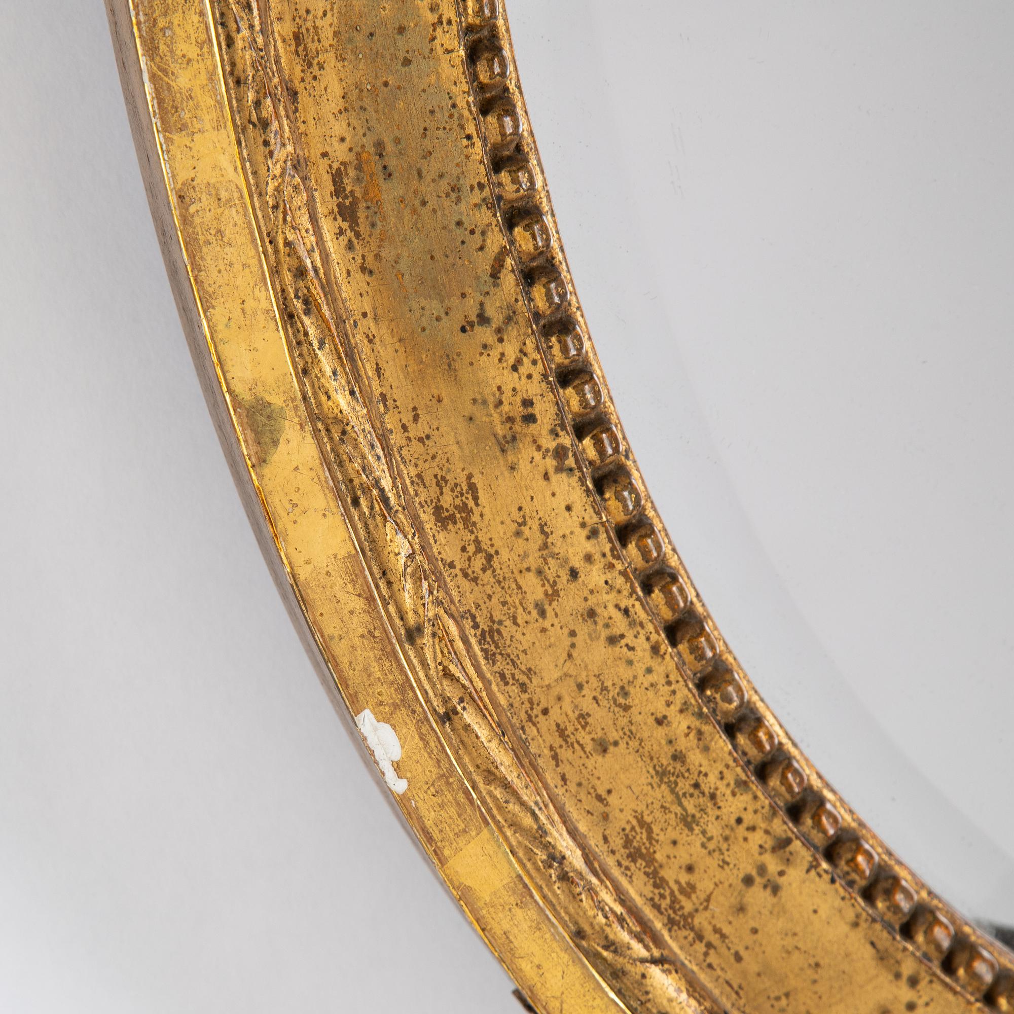 A Gustavian two-light girandole mirror, Stockholm, late 18th century.
