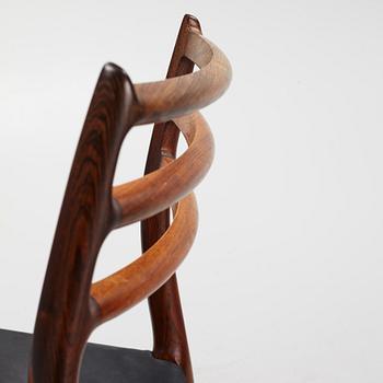 Niles Otto Møller, a rosewood veneered table with four chairs, JL Møller, Denmark, 1950's/60's.
