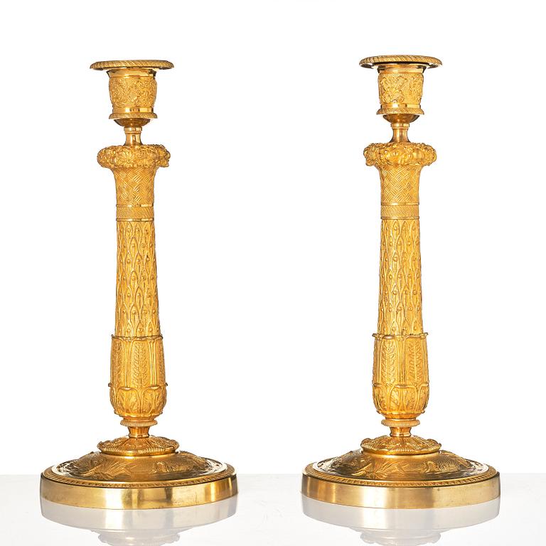 A pair of French Empire candlesticks.