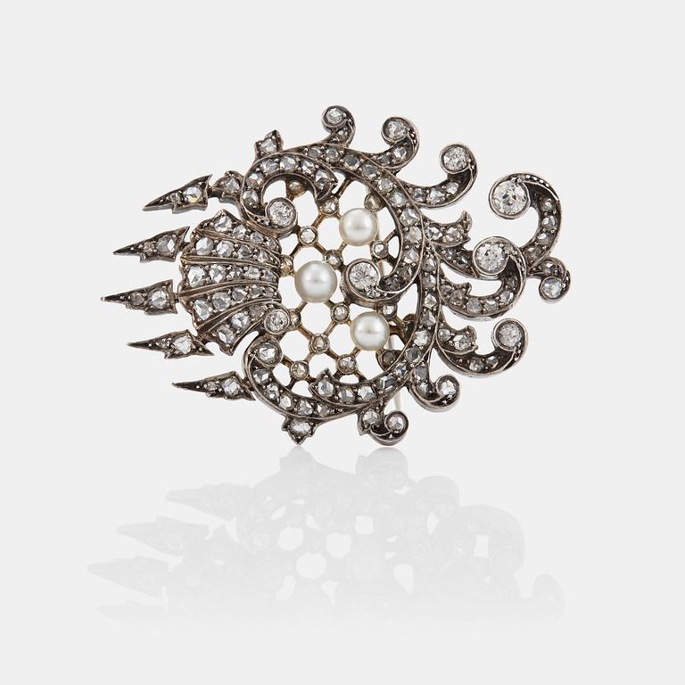 An 18K gold and silver brooch set with old- and rose-cut diamonds.