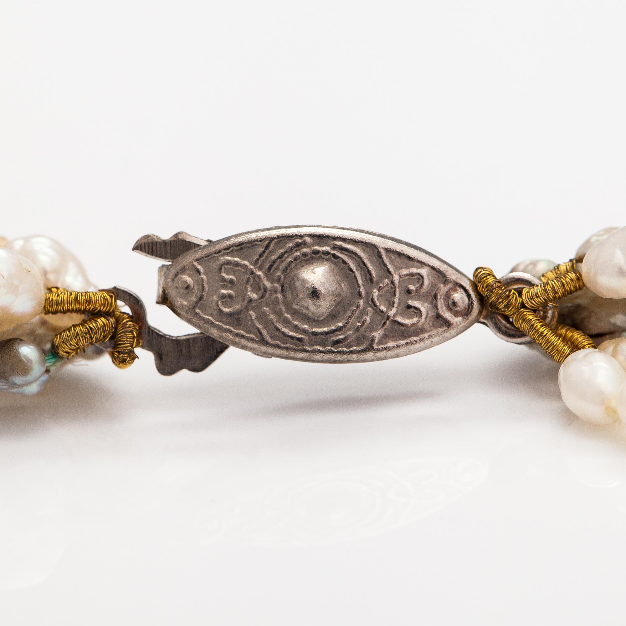 A six-strand pearlcollier with cultured pearls and a metal clasp.